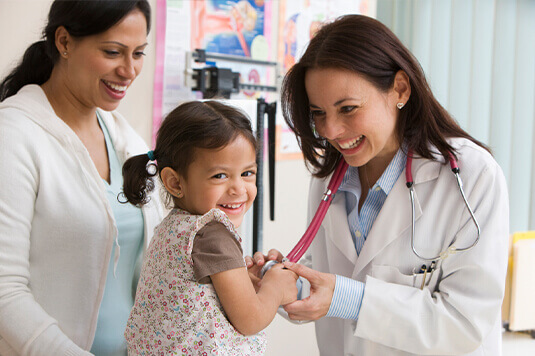 pediatrician treating young girl treatment care