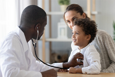 pediatrician treating young boy